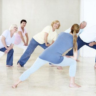 people of all ages stretching in yoga class