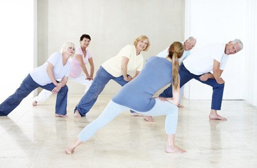 people of all ages stretching in yoga class
