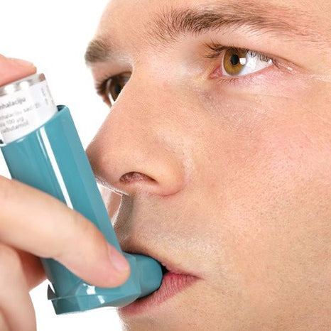 man using inhaler natural asthma relief