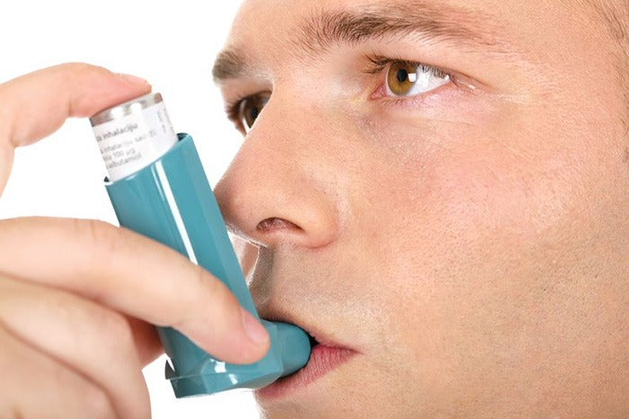 man using inhaler natural asthma relief