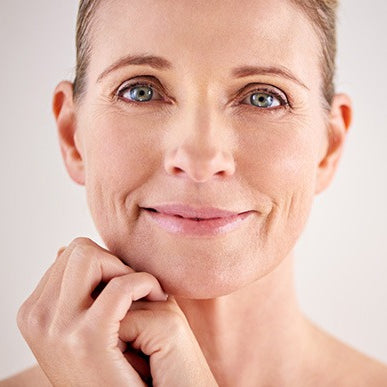 beautiful middle aged smiling woman with radiant facial skin
