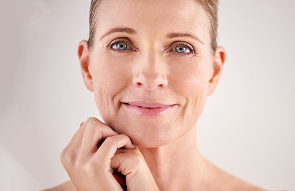 beautiful middle aged smiling woman with radiant facial skin